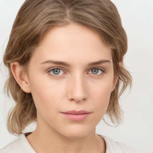 Neutral white young-adult female with medium  brown hair and grey eyes