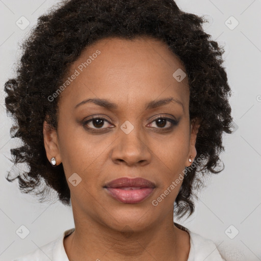 Joyful black adult female with medium  brown hair and brown eyes