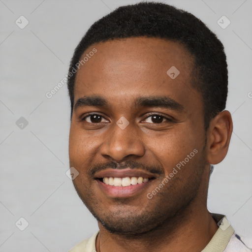 Joyful black young-adult male with short  black hair and brown eyes