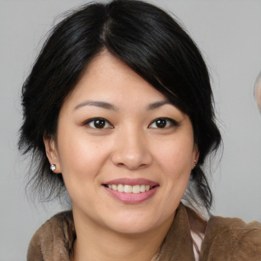 Joyful asian young-adult female with medium  brown hair and brown eyes