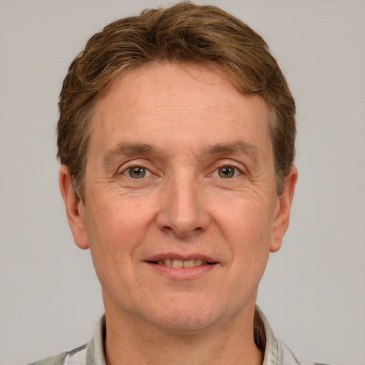 Joyful white adult male with short  brown hair and grey eyes