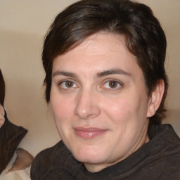 Joyful white adult female with medium  brown hair and brown eyes