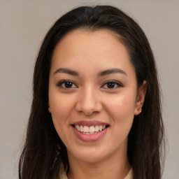 Joyful latino young-adult female with long  brown hair and brown eyes