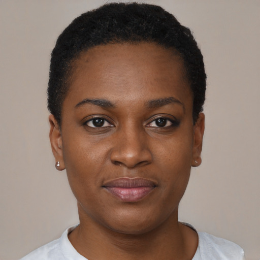 Joyful black young-adult female with short  black hair and brown eyes