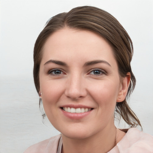 Joyful white young-adult female with medium  brown hair and grey eyes