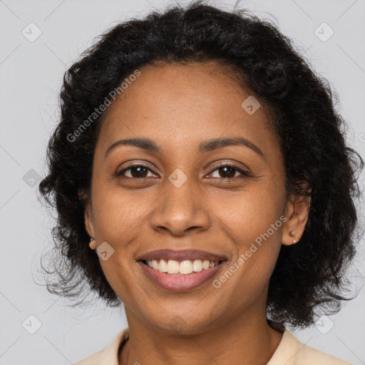 Joyful black adult female with medium  brown hair and brown eyes