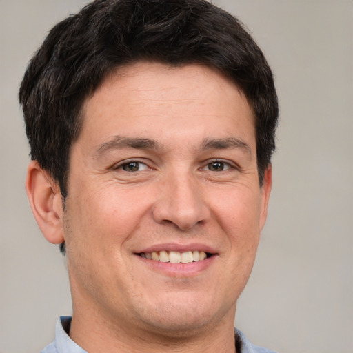 Joyful white adult male with short  brown hair and brown eyes