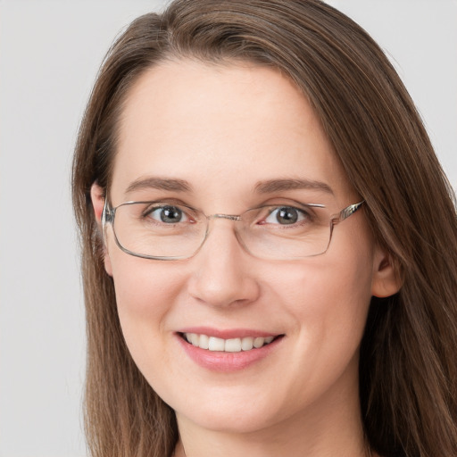 Joyful white young-adult female with long  brown hair and grey eyes