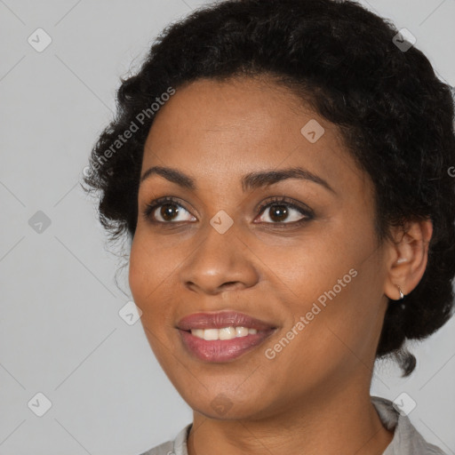 Joyful black young-adult female with short  black hair and brown eyes