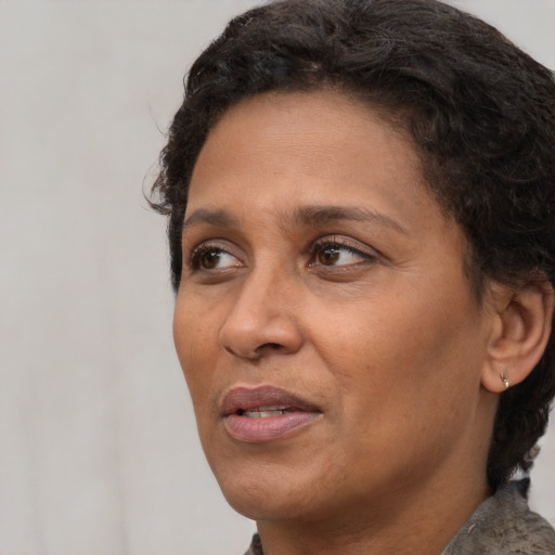 Joyful white adult female with short  brown hair and brown eyes
