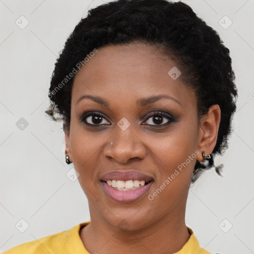 Joyful black young-adult female with short  black hair and brown eyes