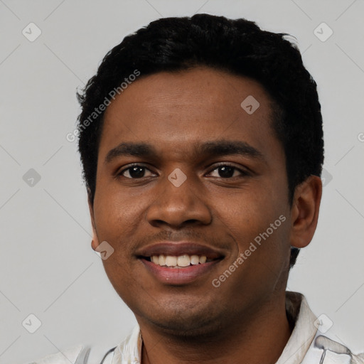 Joyful black young-adult male with short  black hair and brown eyes