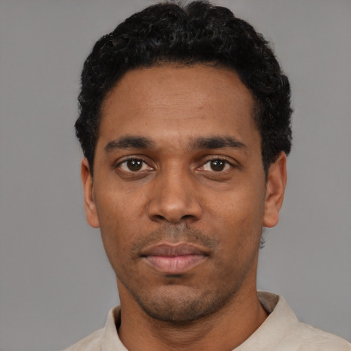 Neutral black young-adult male with short  black hair and brown eyes