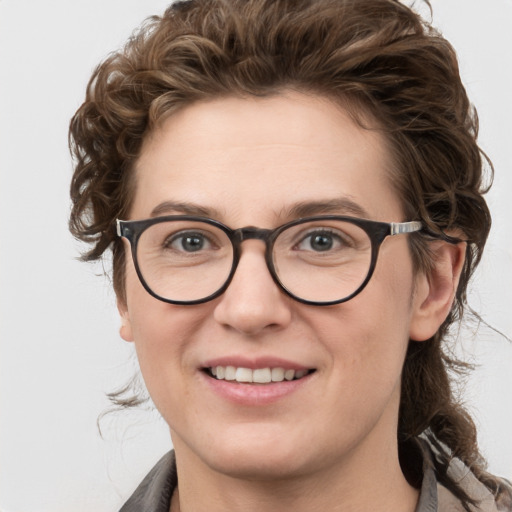 Joyful white young-adult female with medium  brown hair and blue eyes