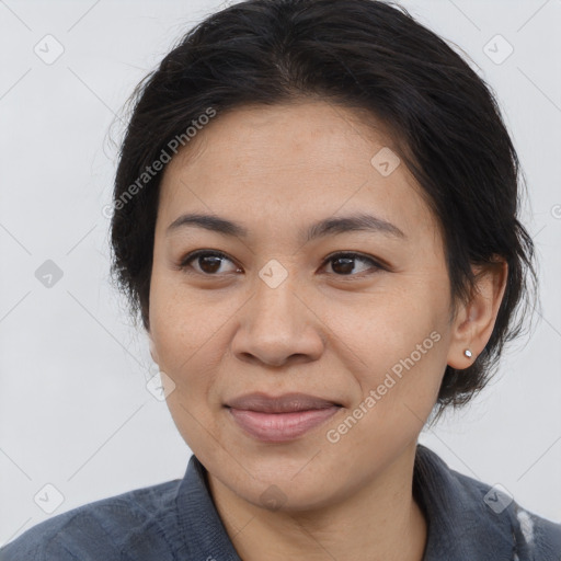 Joyful asian adult female with medium  brown hair and brown eyes
