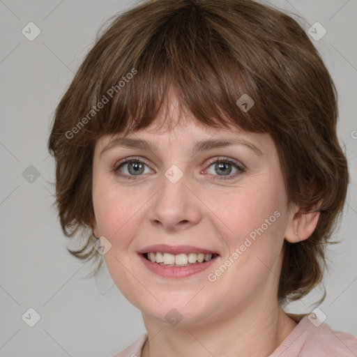 Joyful white young-adult female with medium  brown hair and blue eyes