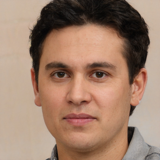 Joyful white adult male with short  brown hair and brown eyes