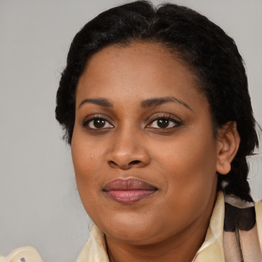 Joyful black adult female with medium  brown hair and brown eyes