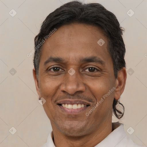 Joyful black adult male with short  brown hair and brown eyes