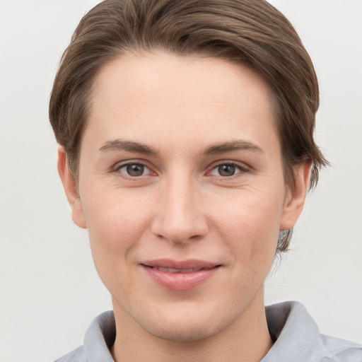 Joyful white young-adult female with short  brown hair and grey eyes