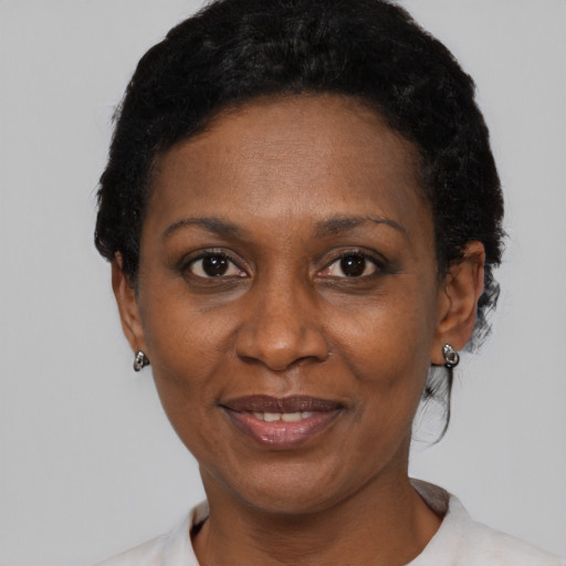 Joyful black adult female with short  black hair and brown eyes