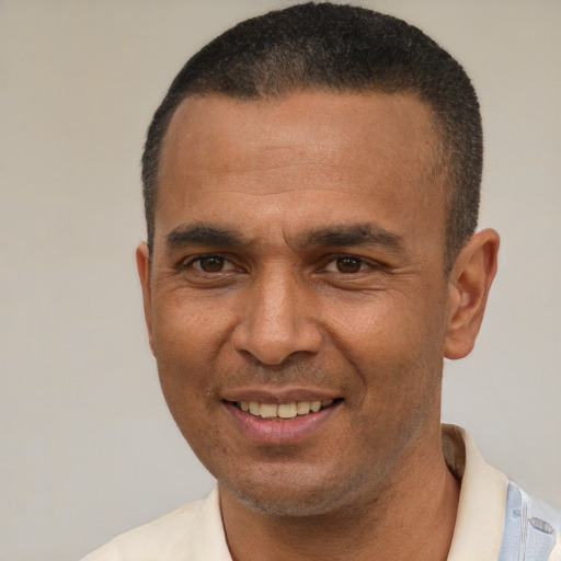 Joyful latino adult male with short  brown hair and brown eyes