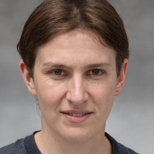 Joyful white young-adult female with medium  brown hair and grey eyes