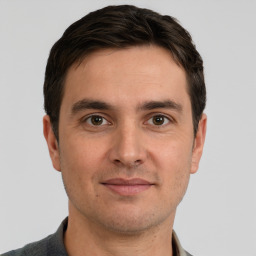 Joyful white young-adult male with short  brown hair and brown eyes