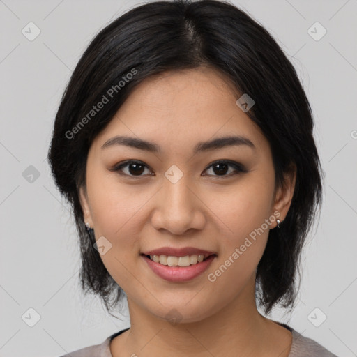 Joyful asian young-adult female with medium  black hair and brown eyes