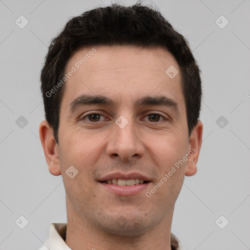 Joyful white young-adult male with short  brown hair and brown eyes