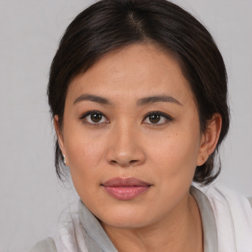 Joyful asian young-adult female with medium  brown hair and brown eyes