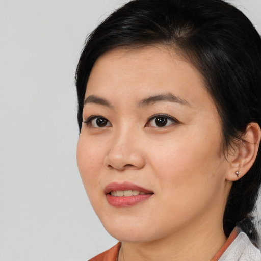 Joyful asian young-adult female with medium  brown hair and brown eyes
