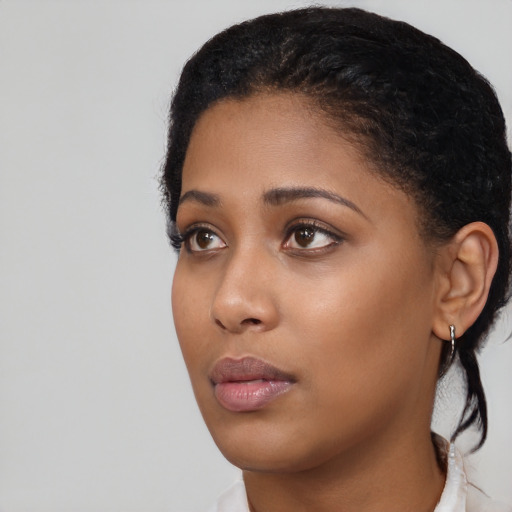 Neutral black young-adult female with medium  black hair and brown eyes