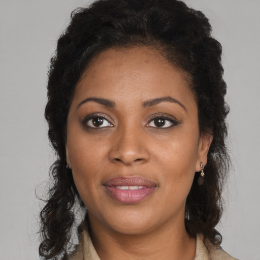 Joyful black young-adult female with medium  brown hair and brown eyes