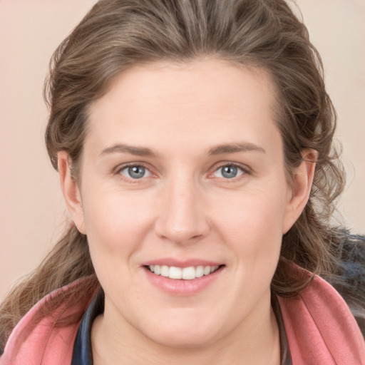 Joyful white young-adult female with long  brown hair and grey eyes