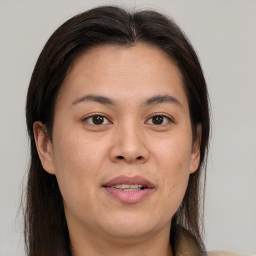Joyful white adult female with medium  brown hair and brown eyes