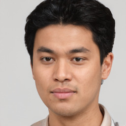 Joyful asian young-adult male with short  black hair and brown eyes