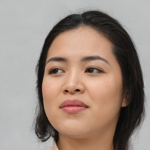 Joyful asian young-adult female with long  brown hair and brown eyes