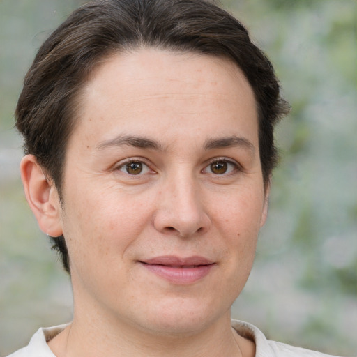 Joyful white adult female with short  brown hair and brown eyes