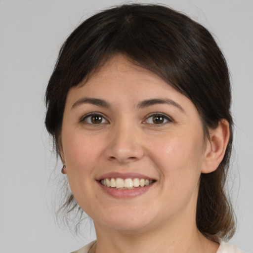 Joyful white young-adult female with medium  brown hair and brown eyes