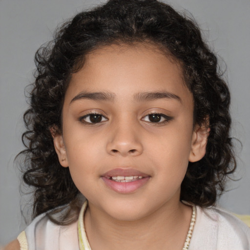 Joyful latino child female with medium  brown hair and brown eyes