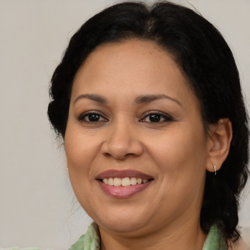 Joyful asian adult female with medium  brown hair and brown eyes