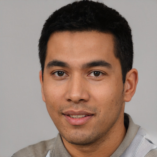 Joyful asian young-adult male with short  black hair and brown eyes