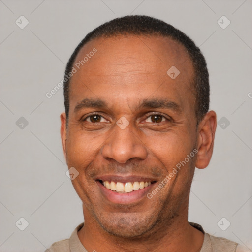 Joyful latino adult male with short  brown hair and brown eyes