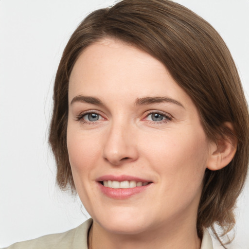 Joyful white young-adult female with medium  brown hair and grey eyes