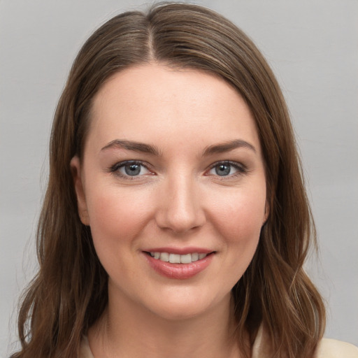 Joyful white young-adult female with medium  brown hair and grey eyes