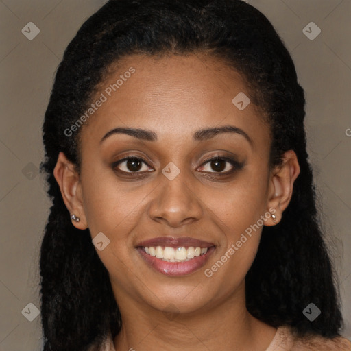 Joyful black young-adult female with long  brown hair and brown eyes