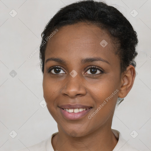 Joyful black young-adult female with short  black hair and brown eyes