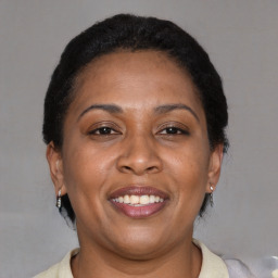 Joyful latino adult female with short  brown hair and brown eyes