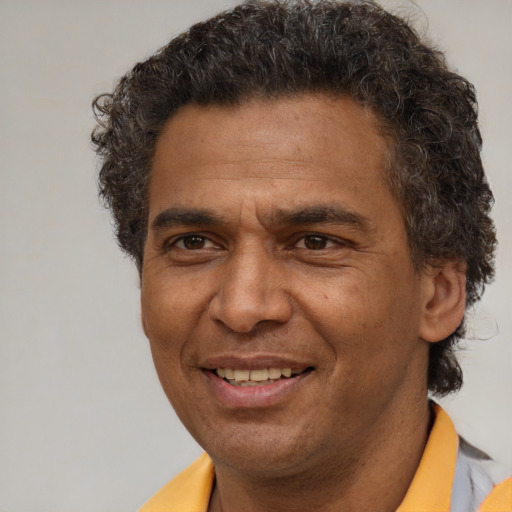 Joyful latino adult male with short  brown hair and brown eyes
